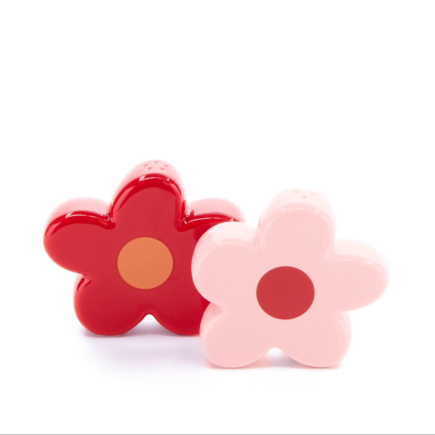 pink and red daisy salt and pepper shakers on a white background.